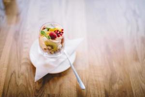 Healthy dessert in a glass on a wooden table photo