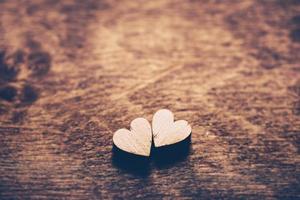 Two hearts on a wooden background photo