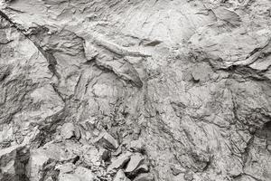 Cliff erosion. Mud, natural clay, cracks in rock background. photo