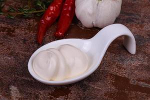 Mayonnaise sauce in the white bowl served thyme and garlic photo