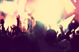 Concert, disco party. People with hands up in night club. photo