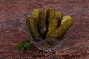 Pickled cucumbers heap in the bowl photo