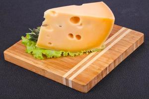 Maasdam cheese  in the board served salad leaves photo