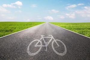 Bike symbol on long straight asphalt road, way photo