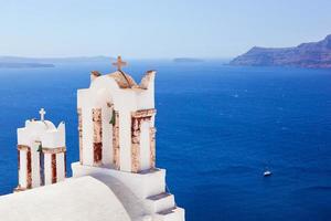 Oia town on Santorini island, Greece. Caldera on Aegean sea. photo