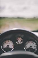 Car cockpit and a dirt road in the field. photo