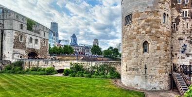 London, England, 2022 - The Tower of London and the city district with Gherkin skyscraper, the UK. photo