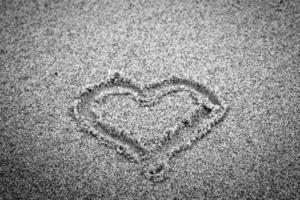 Heart shape on sand. Romantic, black and white photo