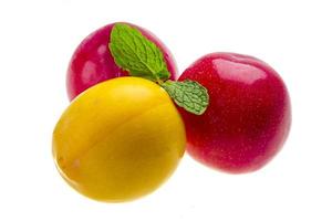 Bright ripe plum with mint photo