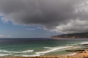 The waves fighting about deserted rocky coast of Atlantic ocean, Portugal photo