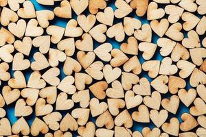 Wooden hearts on blue background. photo