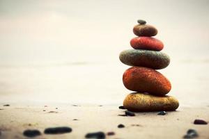 Stacked pebbles on sand photo