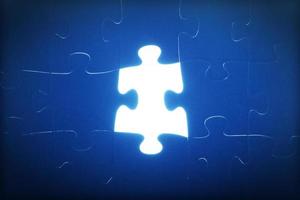 Jigsaw puzzle piece missing. Light glowing. Solution, solve the problem. photo