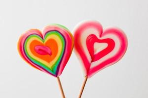 Colorful heart shaped lollipops on grey background photo