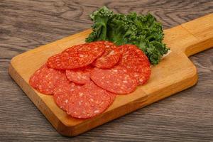 Italian spycy pepperoni sausage slices photo