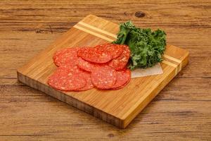 Italian spycy pepperoni sausage slices photo