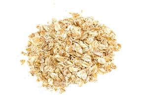 Heap of dry rolled oats isolated on white background photo