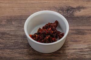 Fried chili pepper sauce with oil photo