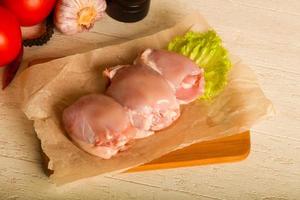 Boneless raw chicken thighs photo