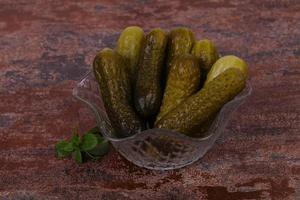 Pickled cucumbers heap in the bowl photo