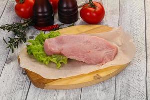Raw Turkey steak served rosemary photo
