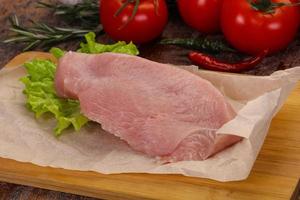 Raw Turkey steak served rosemary photo