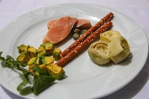 Salmon with avocado and artichoke photo