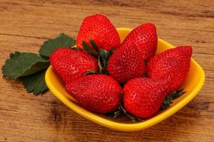 Ripe sweet strawberry with leaf photo