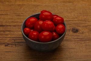 Pickled cherry tomatoes in the bowl photo