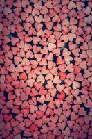 Tiny red hearts on dark background. photo