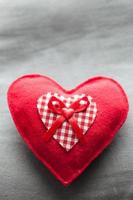 Handmade plush red heart on the soft pillow. Romantic love photo