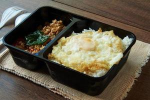 Rice topped with stir-fried pork and basil photo