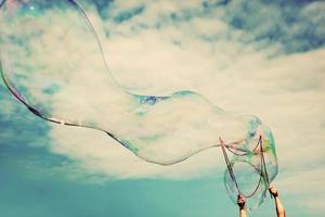 Blowing big soap bubbles in the air. Vintage freedom, summer concepts. photo