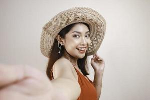 A young beautiful Asian woman taking selfie with holding hand photo