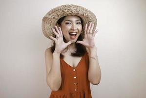 Surprised happy beauty Asian woman shouting in excitement. Beautiful girl act like a telling something Isolated on white background. photo