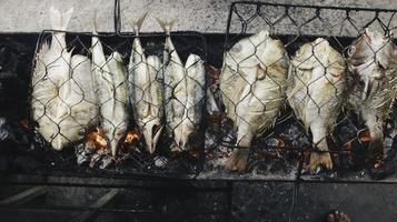 Grilled fish with charcoal for sale at street food market or restaurant in Indonesia photo