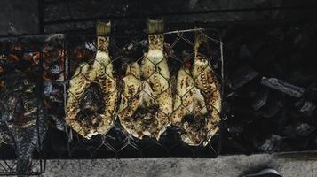 Grilled fish with charcoal for sale at street food market or restaurant in Indonesia photo
