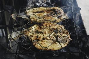 Grilled fish with charcoal for sale at street food market or restaurant in Indonesia photo