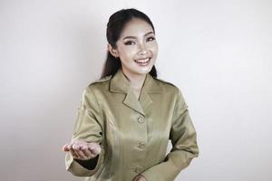 A Young beautiful Asian worker with a brown uniform is presenting. Indonesian PNS. photo