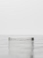 3d glass display podium on water against white background. 3d rendering of realistic presentation for product advertising. 3d minimal illustration. photo
