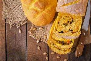 Fresh homemade pumpkin bread and pumpkin slices and olives photo