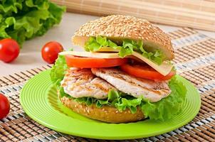 Chicken sandwich with salad and tomato photo