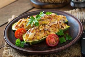 Stuffed zucchini with chicken, tomatoes and onion with cheese crust photo