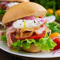 Sandwich with bacon and poached egg photo