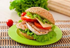 Chicken sandwich with salad and tomato photo