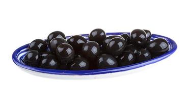 Olives black watered with olive oil in a bowl isolated on a white background photo