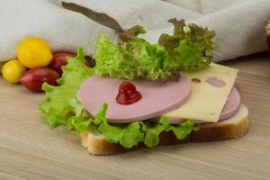 Sandwich with cheese and sausages photo