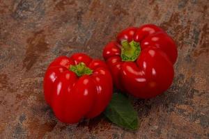 Ripe Red bell pepper over wooden photo