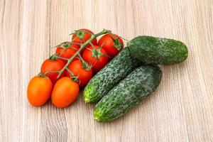 Cucumbers and tomatoes on the branch photo