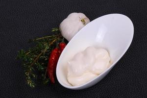 Mayonnaise sauce in the white bowl served thyme and garlic photo